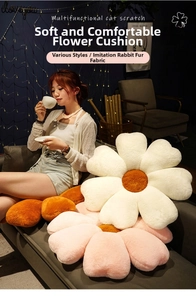 Detail of plush flower-shaped cushions in cream, pink, and orange on a cozy sofa