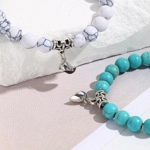 Detailed macro view of white and blue stone beaded magnetic heart charm bracelets