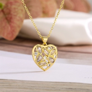 Macro shot of 925 sterling silver heart pendant with floral cutouts and clear zircons