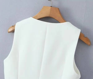 Close-up of the back neckline and shoulder stitching on a white tailored suit vest