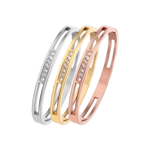 Three minimalist stainless steel bangles in silver, gold, and rose gold with zircon stones