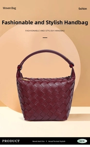 Detailed view of dark red woven handbag with intricate leather texture and golden zipper
