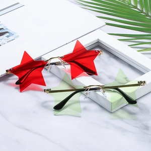 Fashionable rimless star-shaped sunglasses with red and green lenses on marble background