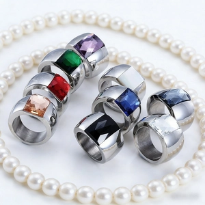 Collection of eight colorful square-cut gemstone rings displayed on a pearl necklace
