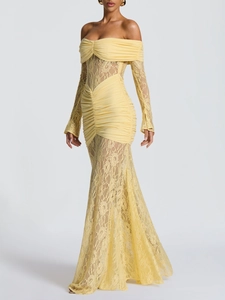 Close-up of elegant pale yellow lace dress featuring off-shoulder design and pleats