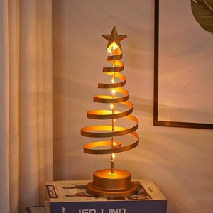 Close-up of golden spiral iron Christmas tree lamp with warm LED starry lights