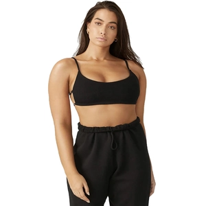 Detail of black knitted cropped tank top and high-waist drawstring cotton joggers