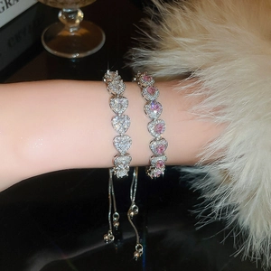Detailed view of pink and white heart-shaped gemstone bracelets with slider clasp