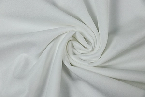 Close-up of white knit mesh fabric with breathable texture and soft drape detail