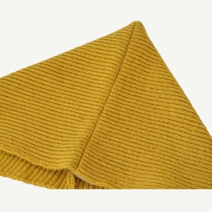 Close-up of yellow ribbed knit texture on a winter hooded shawl scarf and hat set
