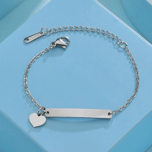 Detail of adjustable stainless steel ID bar bracelet with a heart charm and lobster clasp