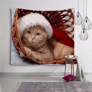 Detail view of Christmas cat tapestry hanging on a textured white brick wall in a cozy room