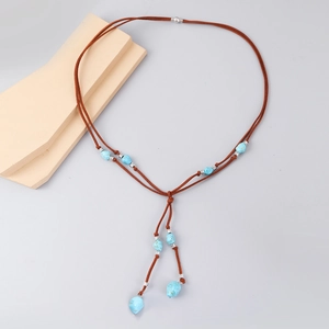 Detail view of Bohemian Y-shaped necklace with turquoise beads on brown suede cord