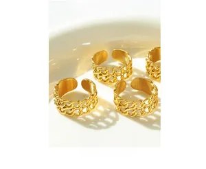Set of four vintage gold double-layer chain link open rings on a white ceramic plate