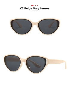 Detail view of retro cat-eye sunglasses in cream frame with dark grey lenses