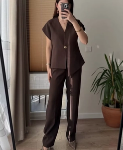 Detail of dark brown two-piece set featuring V-neck single-button top and wide-leg trousers