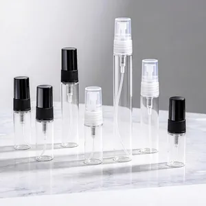 Various sizes of transparent glass perfume spray bottles with black and white nozzles