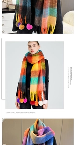 Detail of colorful plaid scarf with soft tassels and decorative plush pom-poms
