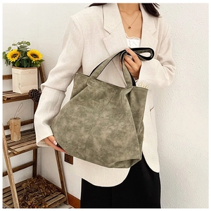 Detail of olive green slouchy tote bag showing the matte suede texture and wide handle