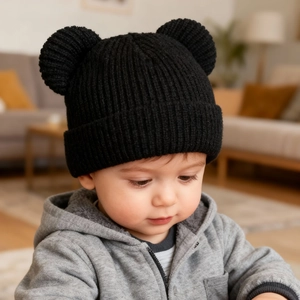 Close-up of a toddler wearing a black ribbed knit beanie with cute bear ears for winter