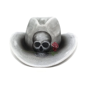 Macro detail of a grey cowboy hat featuring a black skull and red rose graphic