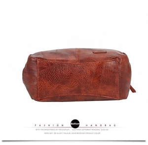Detail view of the durable leather bottom with fashion handbag lettering and fine grain