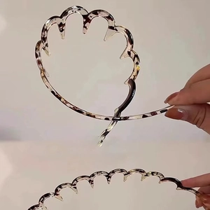 Detailed view of flexible leopard print headband folding mechanism for easy storage