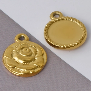 Close-up of golden 304 stainless steel rose relief and rope-edged round pendants