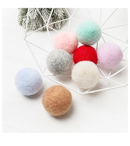 Colorful wool felt balls in a decorative wire basket for Christmas DIY tree ornaments