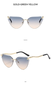 Close-up of rimless cat-eye sunglasses with gold metal legs and gradient lenses