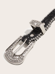 Close-up of sparkling rhinestone western belt with horseshoe buckle and silver studded edges