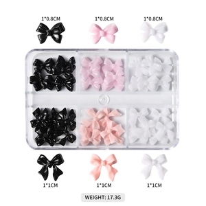 Detailed view of assorted resin butterfly nail charms in various sizes and colors