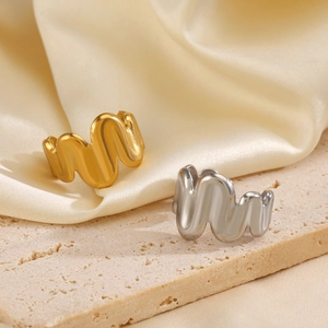 Minimalist wavy open rings in 18K gold and silver plating on textured stone