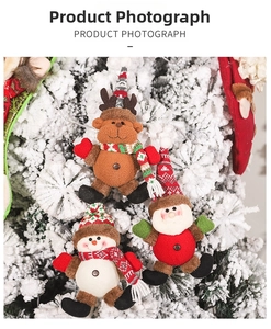 Detail of plush Christmas tree hanging ornaments featuring Santa, reindeer and snowman