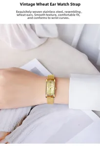 Macro shot of gold rectangular watch dial with wheat pattern mesh strap on wrist