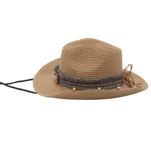 Detail of a brown straw cowboy hat with colorful beads, fringe tassels and woven bands