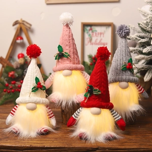 Set of 4 glowing Christmas gnomes with knitted hats and warm LED lights for holiday decor