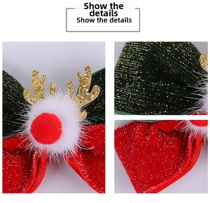 Detail of Christmas reindeer antler hair clip with velvet bow and fluffy pompom
