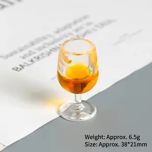 Macro view of a 38x21mm miniature wine glass charm with orange resin filling