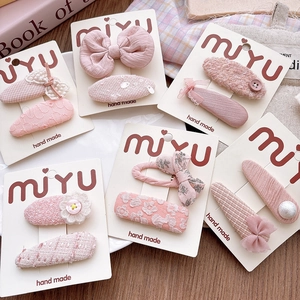 Detailed set of pink fabric bow hair clips for girls featuring lace and tweed patterns