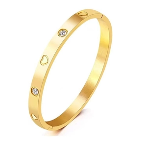 Gold stainless steel bangle with hollow hearts and sparkling round crystals on white background