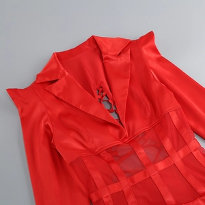 Close-up of red satin dress featuring deep V-neck with mesh patchwork and lace-up detail