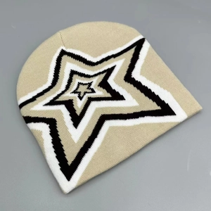 Close-up of knit beanie showing warm beige texture and layered star pattern detail