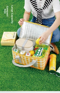 Close-up of insulated yellow checkered picnic basket with thick aluminum foil lining