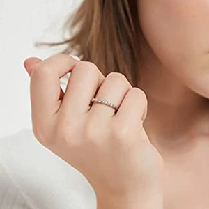 Close-up of elegant silver band ring with pavé diamond texture worn on finger