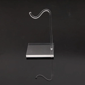 Detailed view of J-shaped clear acrylic jewelry display stand with a square stable base