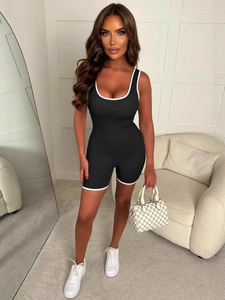 Women's black Y2K athletic yoga romper with white trim details in a slim fit design