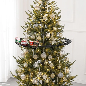 Electric Christmas tree train set with red engine and festive carriages on circular track