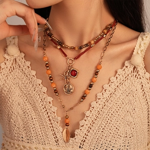 Detail of bohemian multilayer beaded necklace with wooden beads and starfish pendants