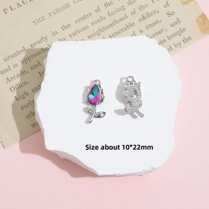 Macro detail of silver rose pendant with colorful rhinestone inlay and 10x22mm size marker